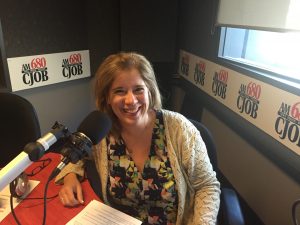 Carolyn Klassen from Conexus Counselling sitting down at the microphone at 680CJOB in Winnipeg in her role as "resident therapist"