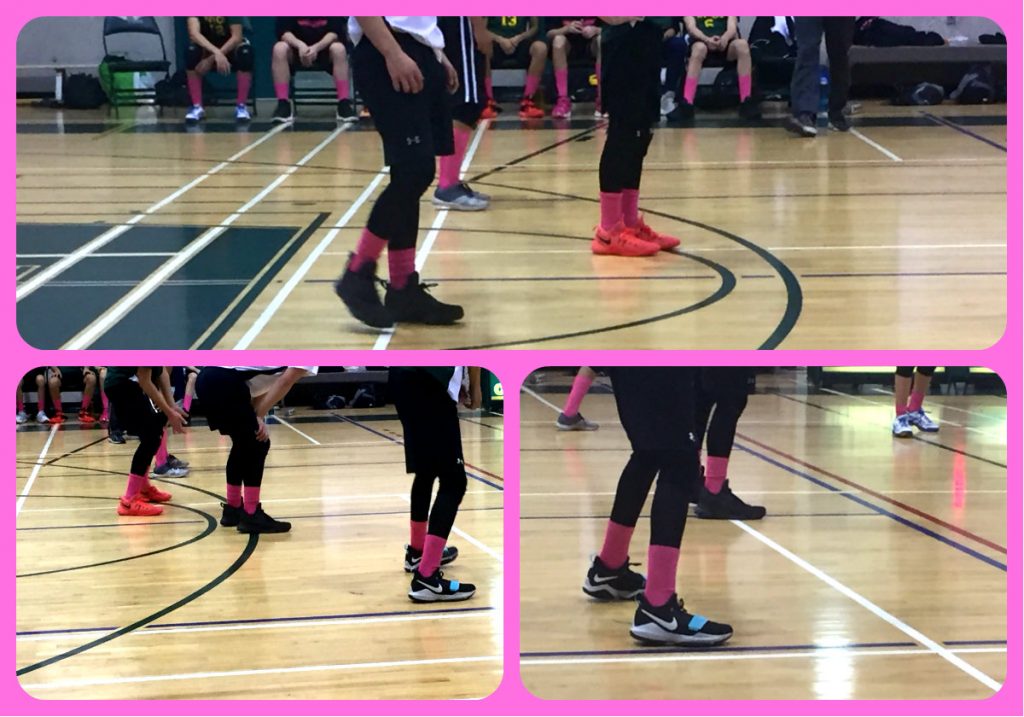 Volleyball court with athletes wearing pink socks in support of team member's mother who died of breast cancer.