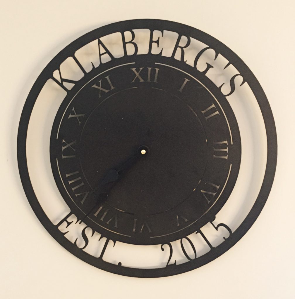Metal clock with Klabergs 2016 around edges