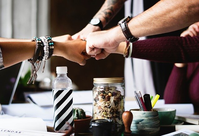 Fist bump between parents who are being the grownup.