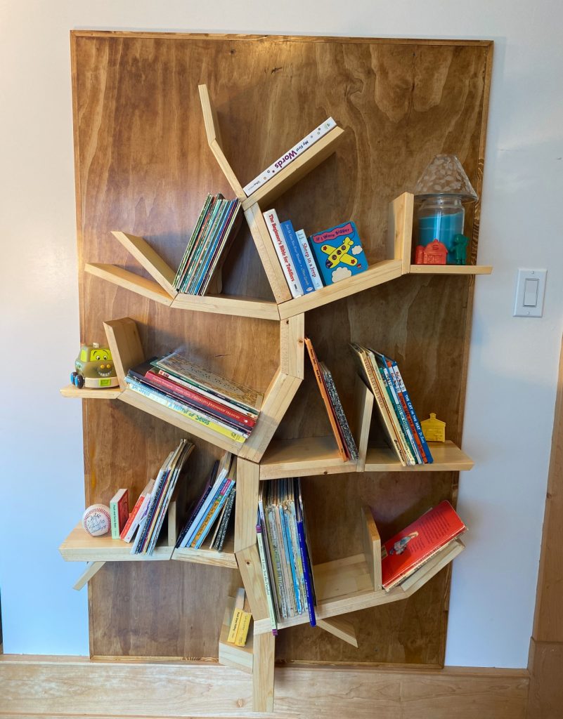 The bookshelf for our grandchildren's books handmade by Husband with wood in the shape of a tree