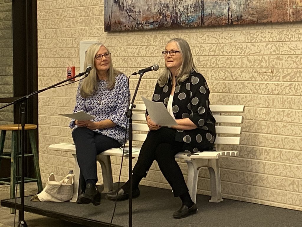 Mary Reimer and Susan Moore at microphones for their book launch of Benchmark